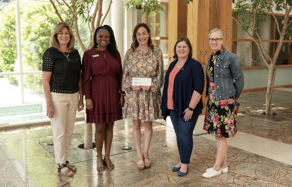 Emily Davis, Executive Vice President of Russel Hill Cancer Foundation presents check to HudsonAlpha Foundation team and Dr. Sara Cooper and Kristy Bell for cancer research and Information is Power Initiative