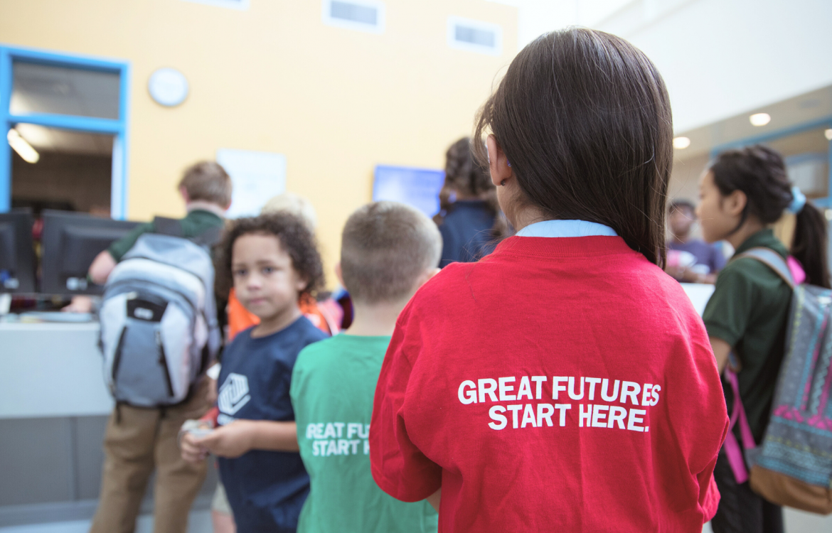 Little girl in line at Boys & Girls Club with t-shirt that reads "Great futures start here"